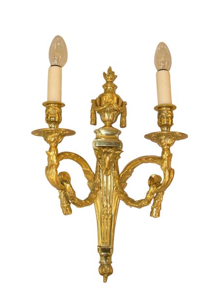 A pair of ormolu aries head Louis XVI style sconces