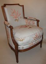 A Louis XVI natural wood bergere armchair 