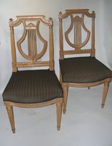 A pair of natural wood lyra shape chairs